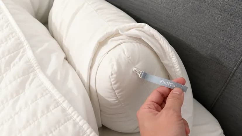Happy couple on FluffCo pillow - man in black hoodie and woman in white